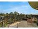 Scenic balcony with decorative wrought iron railing and two chairs overlooking trees and sky at 9101 Alta Dr # 11, Las Vegas, NV 89145