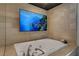This primary bathroom offers a jetted soaking tub and a wall mounted TV, perfect for relaxation at 9101 Alta Dr # 11, Las Vegas, NV 89145
