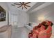 Comfortable bedroom featuring a white couch, massage chair, ceiling fan and a view into the bathroom at 9101 Alta Dr # 11, Las Vegas, NV 89145
