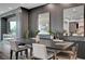 Dining area featuring a sleek black table, chairs, stylish wall decor, and a view of the television at 9101 Alta Dr # 11, Las Vegas, NV 89145