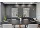 Close up of the dining table and chairs, with neutral tones, accentuated by plant decor and mirror wall art at 9101 Alta Dr # 11, Las Vegas, NV 89145