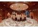 Elegant formal dining room features circular design, exquisite finishes, and custom lighting at 9101 Alta Dr # 11, Las Vegas, NV 89145