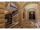 Stone foyer with intricate mosaic tile floors, wrought iron banister, and decorative arched entryway at 9101 Alta Dr # 11, Las Vegas, NV 89145