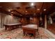 Well-appointed game room features two billiard tables, elegant wood paneling, and custom lighting at 9101 Alta Dr # 11, Las Vegas, NV 89145