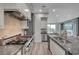 Galley kitchen with updated cabinets, stainless steel appliances and large stone island at 9101 Alta Dr # 11, Las Vegas, NV 89145