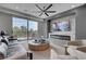 Living area featuring balcony access, a modern television, and comfortable seating at 9101 Alta Dr # 11, Las Vegas, NV 89145