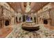 Exquisite living room with detailed stonework, grand chandeliers, and elegant furniture at 9101 Alta Dr # 11, Las Vegas, NV 89145