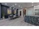 Spacious living room featuring black accent wall, dining area and view into the kitchen at 9101 Alta Dr # 11, Las Vegas, NV 89145