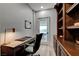 This office features a modern desk, a custom built-in bookshelf, and a door that lets in natural light at 9101 Alta Dr # 11, Las Vegas, NV 89145