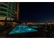 Inviting pool illuminated at night offers a serene retreat in a luxurious setting at 9101 Alta Dr # 11, Las Vegas, NV 89145