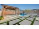A backyard oasis with a pool, spa, gazebo, lounge chairs, and artificial turf accents, perfect for relaxation and entertainment at 9601 Rolling Thunder Ave, Las Vegas, NV 89148