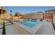 Backyard oasis featuring a pool, spa, gazebo, and a stylish patio area with artificial turf accents for outdoor enjoyment at 9601 Rolling Thunder Ave, Las Vegas, NV 89148