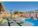 Beautiful backyard featuring a gazebo, pool, spa, lounge chairs, artificial turf accents and a private, serene outdoor space at 9601 Rolling Thunder Ave, Las Vegas, NV 89148