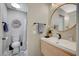 Charming bathroom with a round mirror, modern vanity, and decorative accents at 9601 Rolling Thunder Ave, Las Vegas, NV 89148