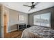 Comfortable bedroom offering a ceiling fan, wood floors, and a bright window at 9601 Rolling Thunder Ave, Las Vegas, NV 89148