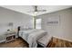 Inviting bedroom featuring wood floors, natural light, and a decorative lamp at 9601 Rolling Thunder Ave, Las Vegas, NV 89148