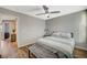Lovely bedroom with a soft bench, natural light, and wood flooring throughout at 9601 Rolling Thunder Ave, Las Vegas, NV 89148
