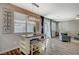 Eat-in kitchen area featuring stylish lighting fixture, breakfast table with seating, and sliding glass door to the yard at 9601 Rolling Thunder Ave, Las Vegas, NV 89148