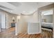 Well-lit hallway with stylish flooring and a view of a bedroom at 9601 Rolling Thunder Ave, Las Vegas, NV 89148
