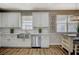 Charming kitchen showcasing white cabinetry, stainless steel appliances, subway tile backsplash and butcher block countertops at 9601 Rolling Thunder Ave, Las Vegas, NV 89148