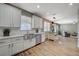 Bright kitchen featuring white cabinets, stainless steel appliances, subway tile backsplash and wood-look floors at 9601 Rolling Thunder Ave, Las Vegas, NV 89148