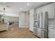 Modern kitchen featuring stainless steel refrigerator, white cabinetry and stainless steel appliances at 9601 Rolling Thunder Ave, Las Vegas, NV 89148