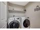 Functional laundry room with modern, front-load washer and dryer at 9601 Rolling Thunder Ave, Las Vegas, NV 89148