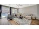 Bright and spacious living room featuring hardwood flooring, modern decor and sliding glass door to backyard at 9601 Rolling Thunder Ave, Las Vegas, NV 89148