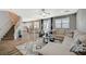Open-concept living room showcases hardwood floors and a view of the modern white kitchen at 9601 Rolling Thunder Ave, Las Vegas, NV 89148