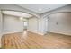 Spacious, open-concept living room with wood floors, neutral walls, arched doorways and modern lighting at 9601 Rolling Thunder Ave, Las Vegas, NV 89148