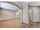Open-concept living room featuring wood floors, neutral walls, arched doorways and recessed lighting at 9601 Rolling Thunder Ave, Las Vegas, NV 89148