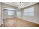 Open-concept living room featuring wood floors, neutral walls, arched doorways and modern lighting at 9601 Rolling Thunder Ave, Las Vegas, NV 89148