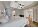 Bright main bedroom featuring tray ceilings, recessed lights, and ample natural light at 9601 Rolling Thunder Ave, Las Vegas, NV 89148