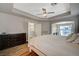 Bright main bedroom featuring tray ceilings, recessed lights, and ample natural light at 9601 Rolling Thunder Ave, Las Vegas, NV 89148