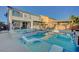 Beautiful backyard pool with a hot tub, lounge chairs, and a covered patio at 9601 Rolling Thunder Ave, Las Vegas, NV 89148