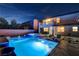 Backyard features a pool, hot tub, patio, and second story balcony at 9601 Rolling Thunder Ave, Las Vegas, NV 89148