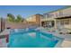 This backyard features a sparkling pool, spa, lounge chairs, and patio, perfect for outdoor relaxation and entertaining at 9601 Rolling Thunder Ave, Las Vegas, NV 89148