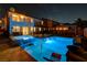 Exterior view of a backyard pool and hot tub under the stars at nighttime at 9601 Rolling Thunder Ave, Las Vegas, NV 89148