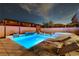 Backyard featuring a rectangular pool, hot tub, and a seating area with lounge chairs at 9601 Rolling Thunder Ave, Las Vegas, NV 89148