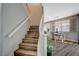 Staircase leading to dining area with table, breakfast bar and modern lighting at 9601 Rolling Thunder Ave, Las Vegas, NV 89148