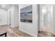 Hallway with wood floors, neutral walls and a decorative painting at 1 Vicolo Bella, Henderson, NV 89011