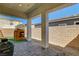 Covered patio featuring a grill, outdoor playhouse, and well-maintained artificial grass at 10064 Ocher Valley Ave, Las Vegas, NV 89178