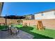 Spacious backyard featuring artificial turf, play area, and covered lounge seating at 10064 Ocher Valley Ave, Las Vegas, NV 89178