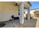 Covered patio includes a grill, playhouse, and artificial grass area, enhancing outdoor living at 10064 Ocher Valley Ave, Las Vegas, NV 89178