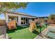 Backyard view featuring artificial turf and play area with privacy fence at 10064 Ocher Valley Ave, Las Vegas, NV 89178
