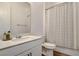 Bright bathroom with a granite-topped vanity, modern fixtures, and a shower with a curtain at 10064 Ocher Valley Ave, Las Vegas, NV 89178