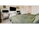 Bedroom featuring a workspace and large bed with view to ensuite bathroom at 10064 Ocher Valley Ave, Las Vegas, NV 89178