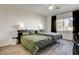 Comfortable bedroom with ample natural light from the window and dark blackout curtains at 10064 Ocher Valley Ave, Las Vegas, NV 89178
