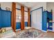 Stylish bedroom features custom blue wainscoting, matching curtains, and ample natural light at 10064 Ocher Valley Ave, Las Vegas, NV 89178