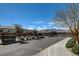 Community entrance sign, mature landscaping, and access gate at 10064 Ocher Valley Ave, Las Vegas, NV 89178